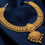 a-luxurious-gold-necklace-draped-over-a-soft-silk-cloth-with-intricate-details-and-a-radiant-shine-creating-an-air-of-elegance-and-wealth-free-photo